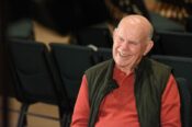 older man smiling during interview in church