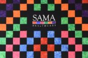 colorful patchwork quilt wall-hanging bearing SAMA clinic logo and color scheme in El Dorado clinic's lobby