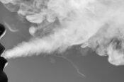 Close-up of a man blowing smoke
