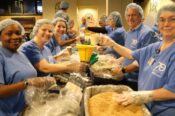 employee volunteers pack nutritious meals